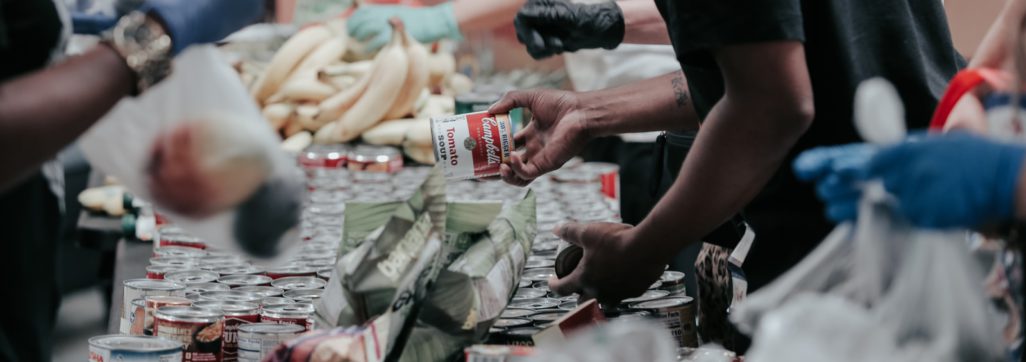 man in black t-shirt holding coca cola bottle