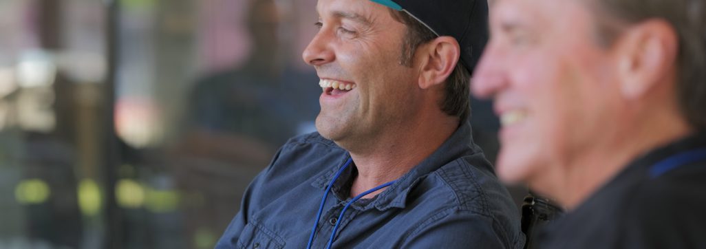 man in blue and white fitted cap and black button up shirt